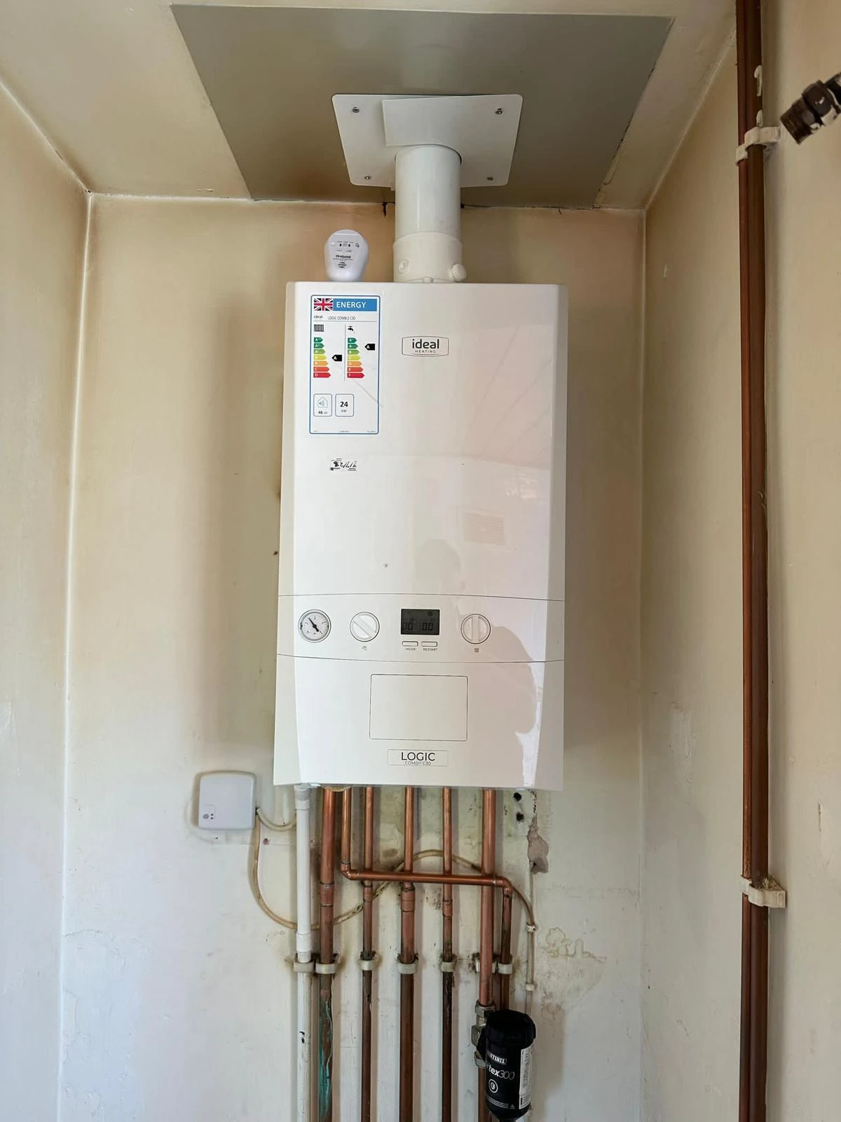 New white boiler in cupboard.